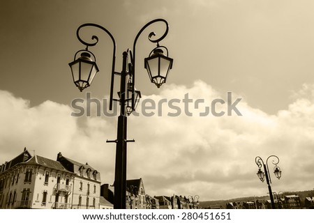 Art Nouveau style buildings and streetlights in resort town Mers-les-Bains (Picardy, France). Aged photo. Sepia.