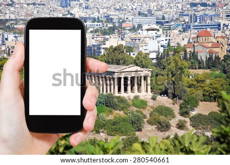 travel concept - tourist photograph Temple of Hephaestus and Athens city view from Acropolis hill, Greece on smartphone with cut out screen with blank place for advertising logo