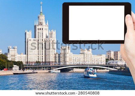 travel concept - tourist photograph Moscow cityscape with Stalin's high-rise building on kotelnicheskaya embankment on tablet pc with cut out screen with blank place for advertising logo