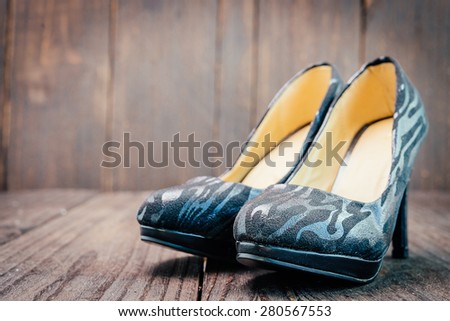 Black high heel on wooden background - vintage effect style pictures