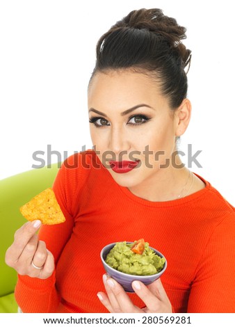Beautiful Young Hispanic Woman In Her Twenties With a Bowl of Homemade Guacamole Dip and Tortilla Chips