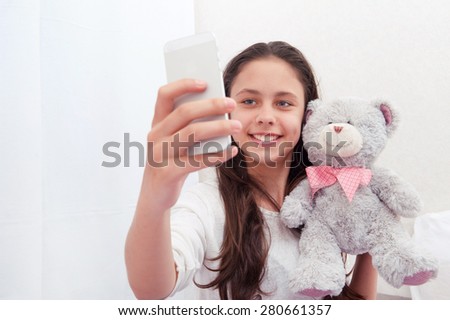 Selfie. girl taken pictures of her self  with teddy bear
