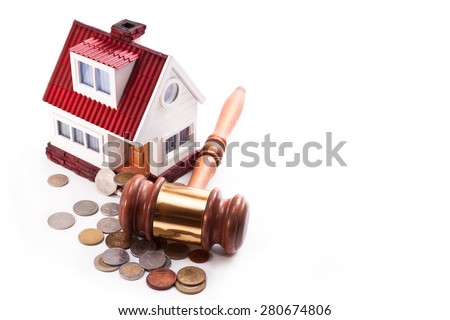 The house with a loft, the auction hammer and coins on a white background
