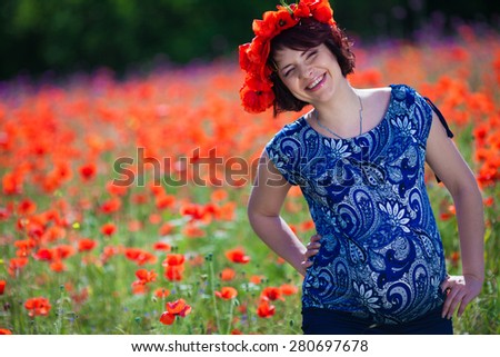 Pregnant woman in poppy field