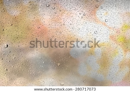Drops of water on glass and abstract Background with bokeh defocused beautiful flowers