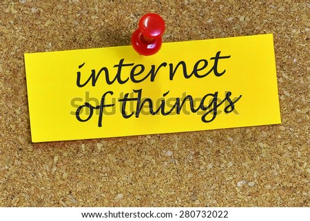 internet of things word on notepaper with cork background.