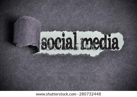 social media word under torn black sugar paper.