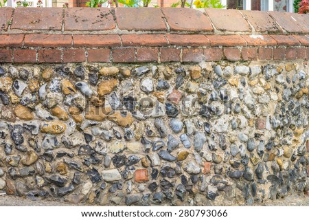 Weathered stone wall of an old street corner in rural England closeup