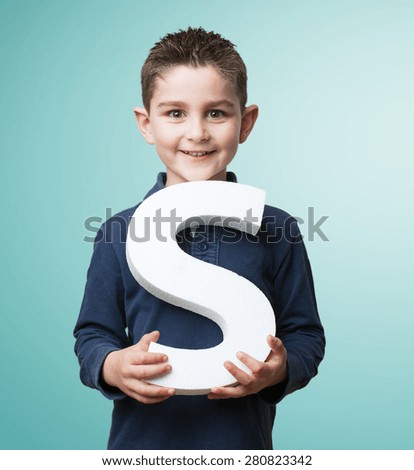 little kid holding the s letter