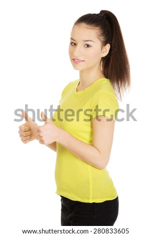 Young happy student woman showing thumbs up.