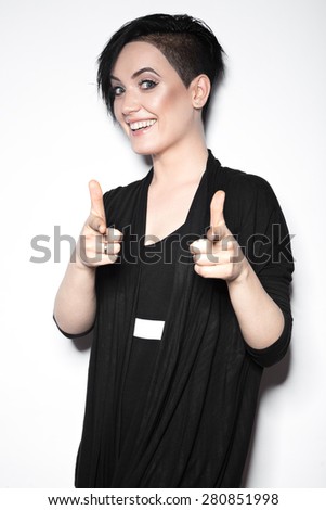 Girl in a black dress with shaved head  in art gothic style. Picture taken in the studio on a white background.