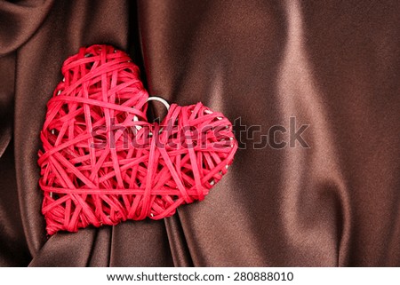 Red heart on fabric background