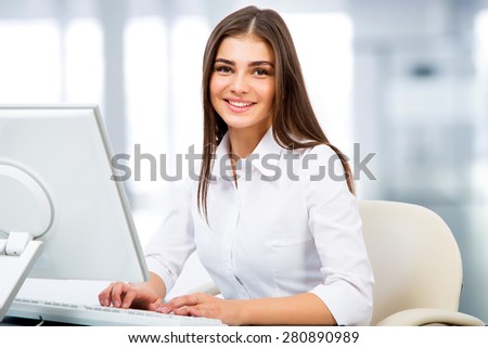 Portrait of a young businesswoman using computer at office