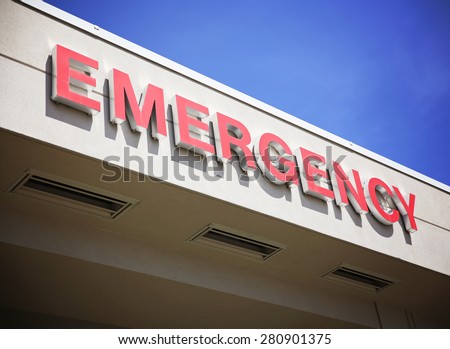 the front entrance sign to an emergency room department in a city hospital