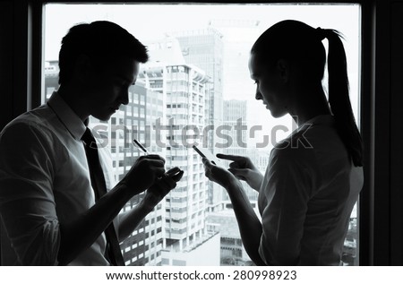 Male and female working in a office setting. 
