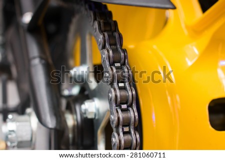 Enduro motorbike wheel and chain. Closeup shot Royalty-Free Stock Photo #281060711