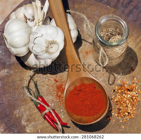 close up picture of a lot  red hot chili peppers and spicy, garlic on wooden kitchen, curry