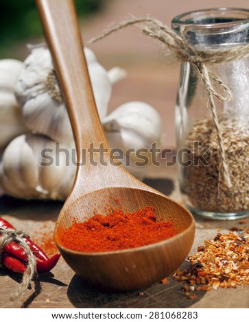 close up picture of a lot  red hot chili peppers and spicy, garlic on wooden kitchen, curry
