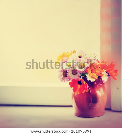 bouquet of garden flowers on old wooden bench 
