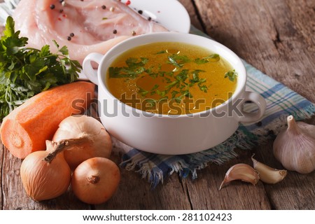 Chicken broth and ingredients on the table close-up. horizontal, rustic style
