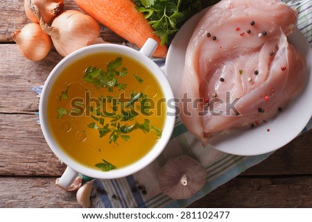 Chicken broth and ingredients on the table. horizontal top view, homemade food
