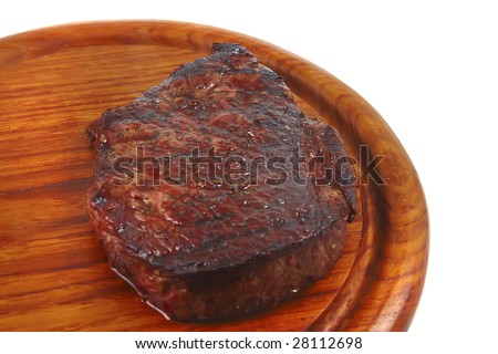 grilled beef on wooden plate over white background
