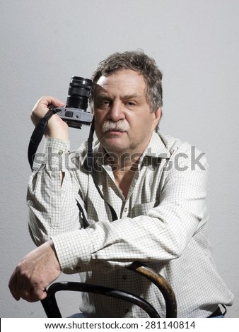 Portrait of middle age and handsome professional photographer 