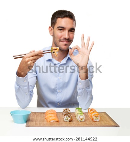 Young man eating sushi