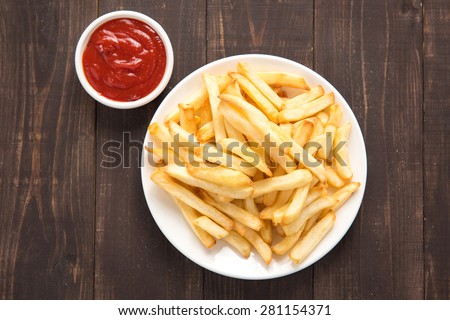 French fries with ketchup on wooden background. Royalty-Free Stock Photo #281154371