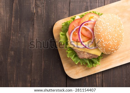 Top view BBQ hamburgers on cutting board on wooden background
