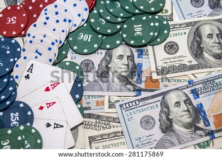 Poker Combination chips, playing cards and usa dollars bills in casino