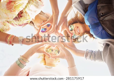 A picture of group of happy friends showing hearts
