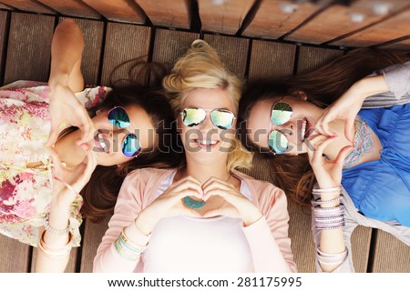 A picture of group of happy friends showing hearts