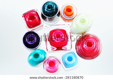 Nail polishes isolated on white. multi -colored nail polish in bottle top view.