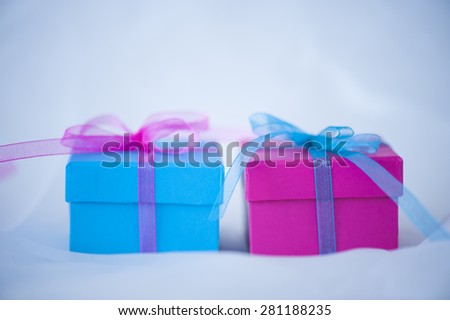 Gift boxes with ribbons on cloth background