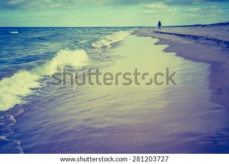 Vintage photo of beautiful beach landscape with cloudy sky and sea with waves. Baltic sea coast near Gdansk in Poland. 