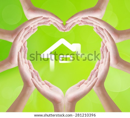 Hands heart shape on home background , concept design