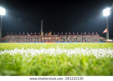 Photo of a green synthetic grass sports field with white line shot.Green grass in soccer stadium: Soccer ball on soccer field. Soccer or football ball symbol on the green field. Soccer ball on field.  Royalty-Free Stock Photo #281222120