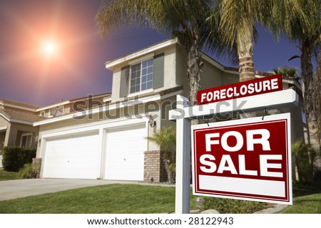 Red Foreclosure For Sale Real Estate Sign in Front of House with Red Star-burst in Sky.