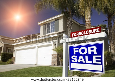 Blue Foreclosure For Sale Real Estate Sign in Front of House with Red Star-burst in Sky.