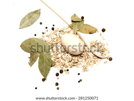 Ingredients. Krupa on a wooden spoon, egg and seasoning. Photo.