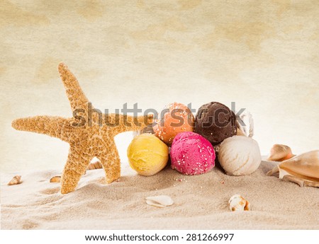 Ice cream scoops on sandy beach, close-up.