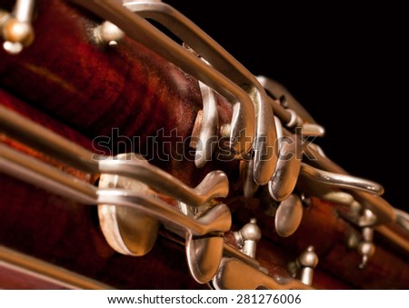 Fragment of the bassoon on a black background Royalty-Free Stock Photo #281276006