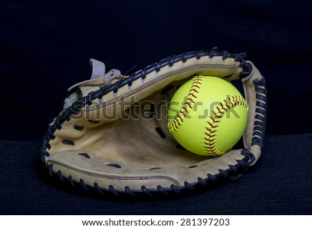 Fastpitch softball mitt with yellow ball.
