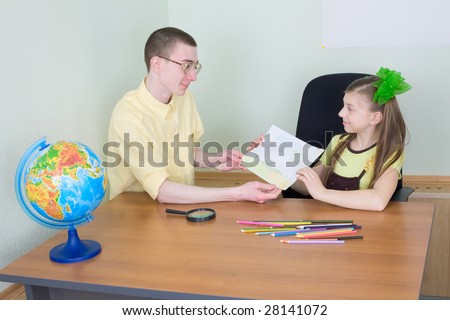 The girl shows new drawing to the brother
