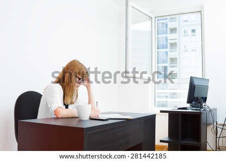 Young office-girl surfing on the internet.