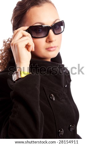 Attractive girl in black coat and sunglasses