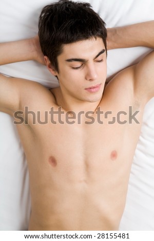 Photo of sleeping young man with his hands under head
