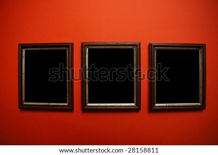 empty pictures on red wall