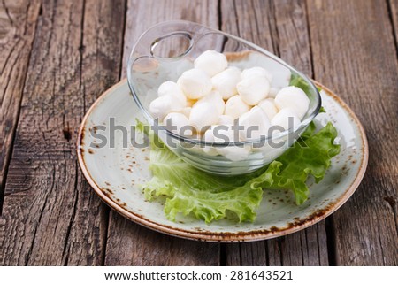 Round mini mozzarella in a glass bowl. selective focus